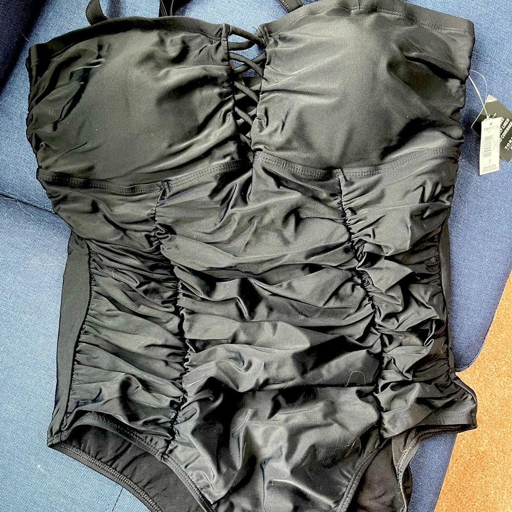 BNWT Torrid black one piece swimsuit with cris-cross cleavage detail.